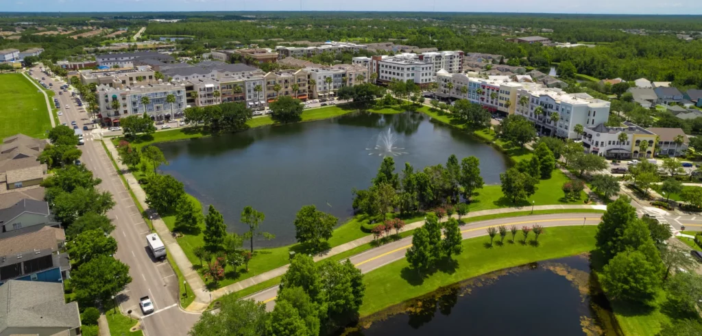 Aerial view of Avalon Park, FL showcasing residential buildings and a lake, highlighting Termite Lawn and Pest's services in the area.