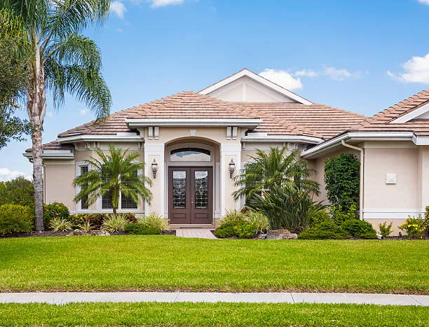 A well-maintained lawn in front of a beautiful house, representing the high-quality lawn care services available in Central Florida.