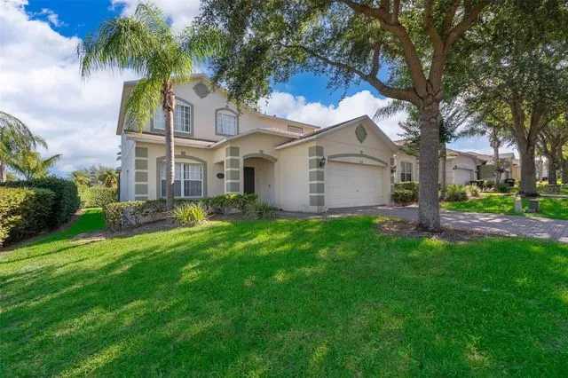 Well-maintained green lawn in front of a house, highlighting the lawn care services offered by Termite Lawn and Pest in Davenport.