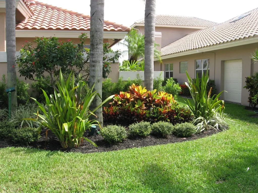 A well-maintained lawn with lush green grass and neatly trimmed shrubs, showcasing the lawn care services offered by Termite Lawn and Pest in Four Corners.