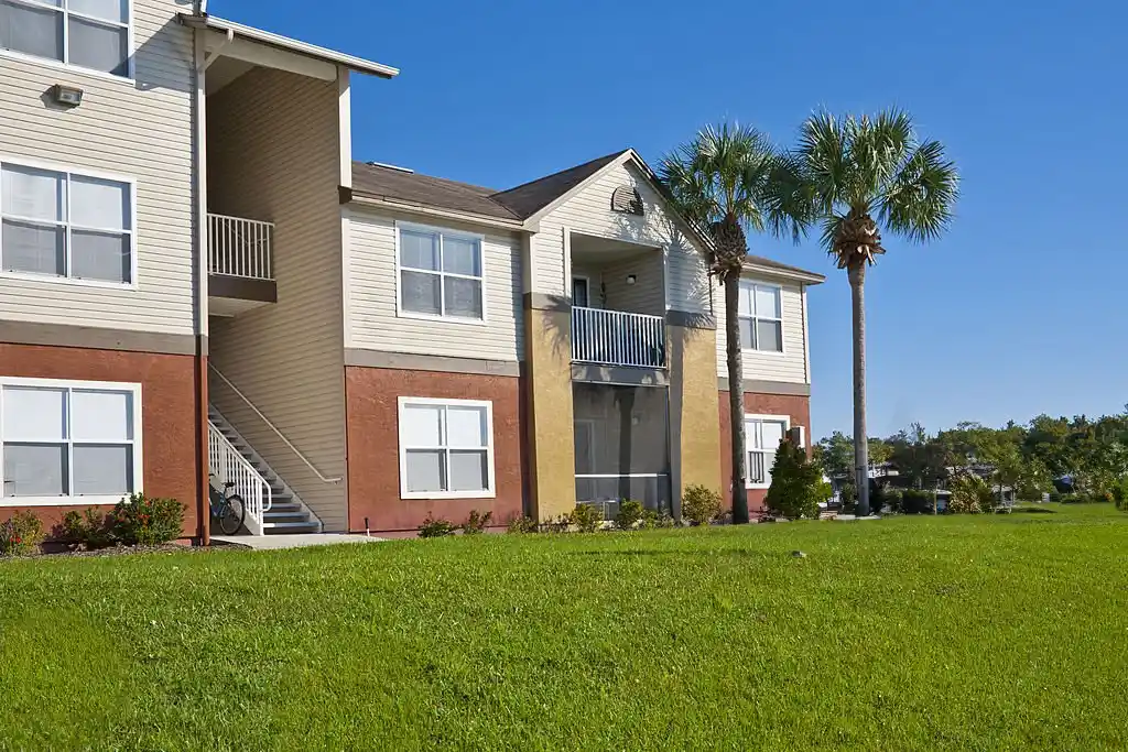 Well-maintained lawn in front of a residential building, showcasing Winter Springs lawn care services.