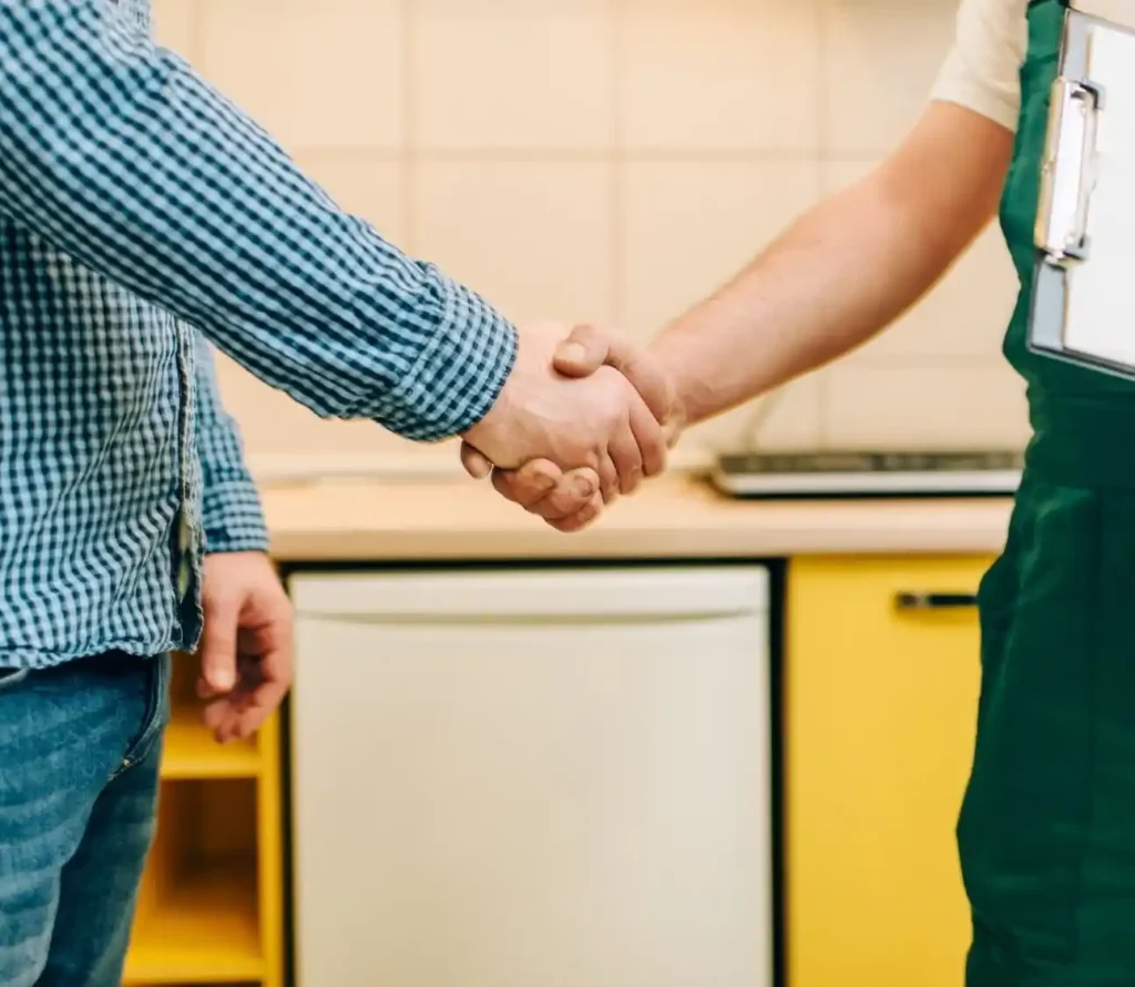 Pest control professional shaking hands with a client, symbolizing the benefits of pest professionals in providing effective pest management.