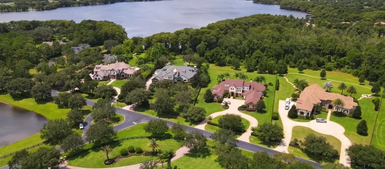 Aerial view of a residential neighborhood in Chuluota with well-maintained lawns and surrounding greenery, showcasing the pest control services by Termite Lawn and Pest.