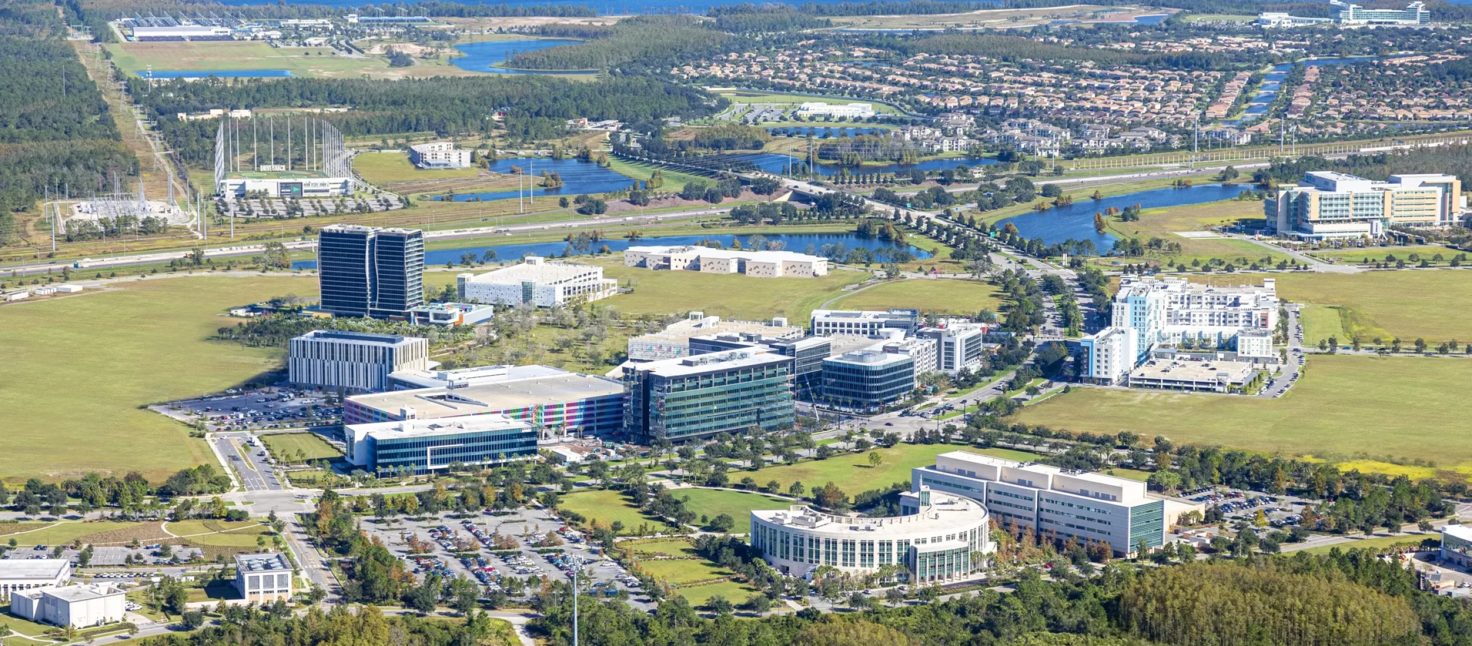 Aerial view of the Lake Nona community, showcasing its well-maintained landscape and buildings, reflecting the comprehensive services that we provide in Lake Nona.