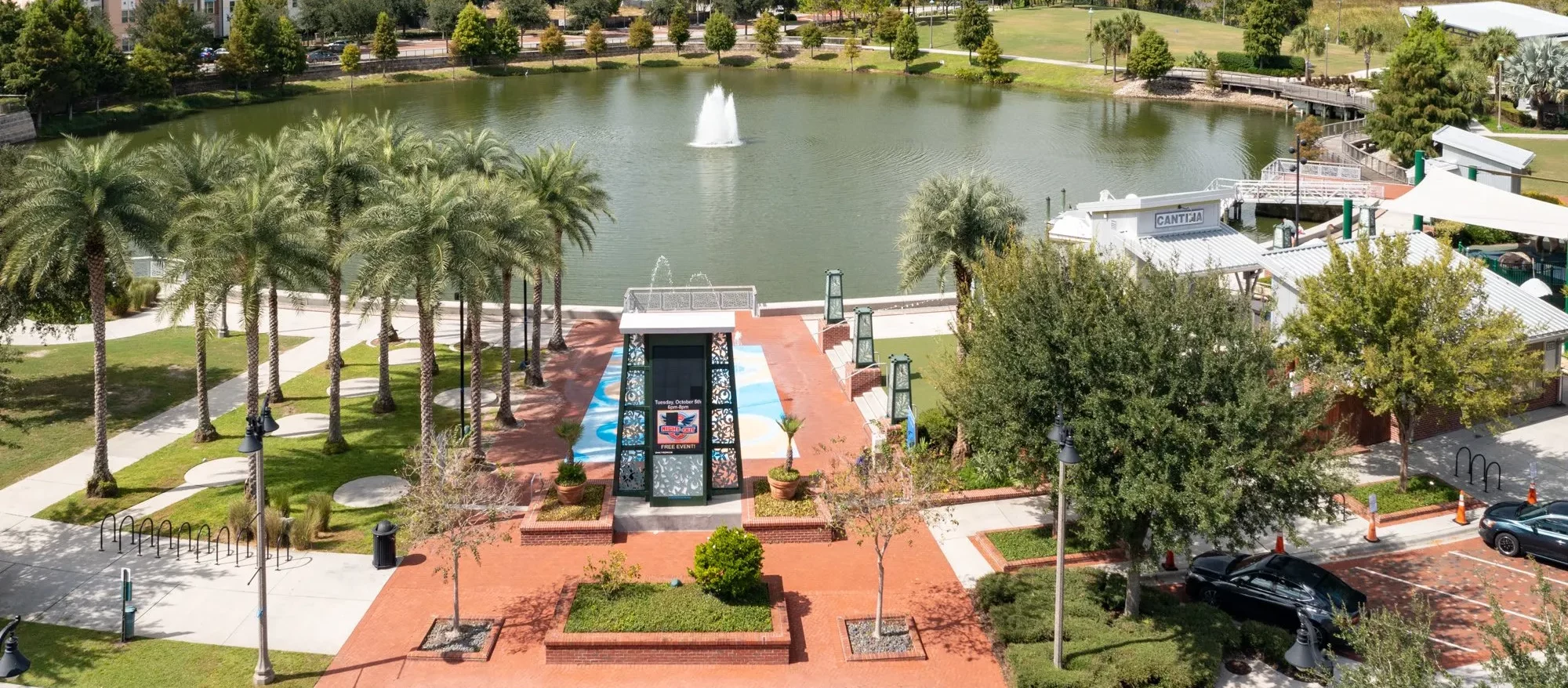 A beautiful park in Oviedo with a lake, fountain, and well-maintained greenery, representing the importance of comprehensive pest control and lawn care services to maintain such serene environments.