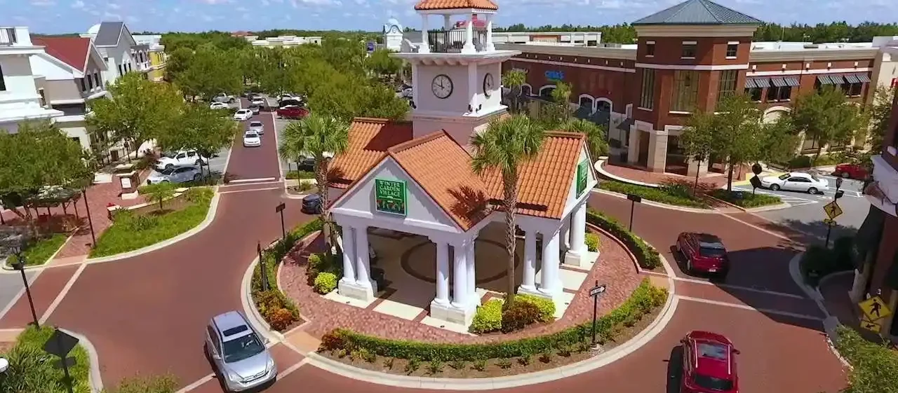 Aerial view of a picturesque town center in Winter Garden with well-maintained landscaping, highlighting the benefits of comprehensive property services.